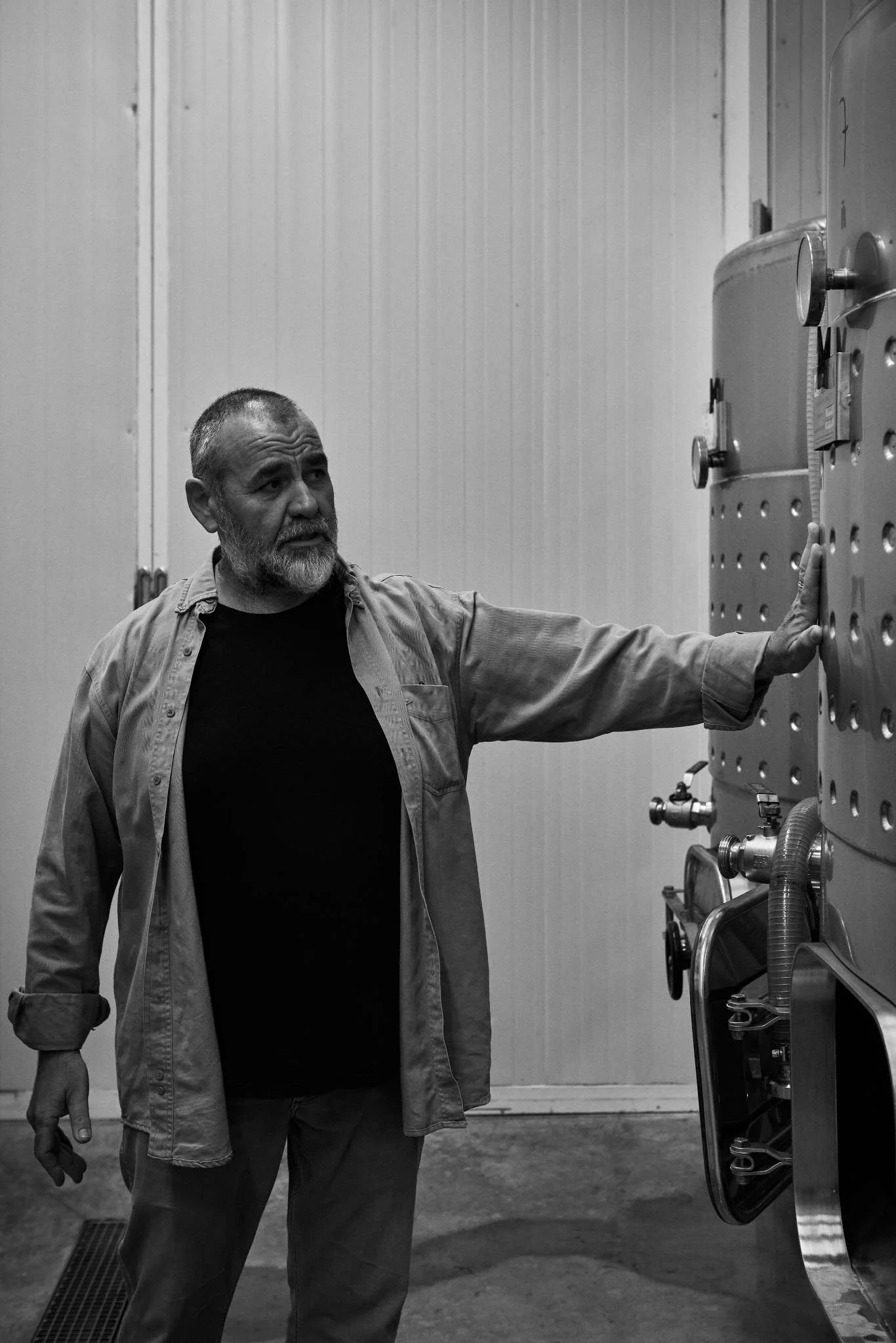Winemaker Toni Xumeu standing next to stainless steel fermentation tanks inside his Toni Xumeu de Can Vinya winery in Ibiza, where he will host and help elaborate Peter Lehner's boutique Ibiza wines.